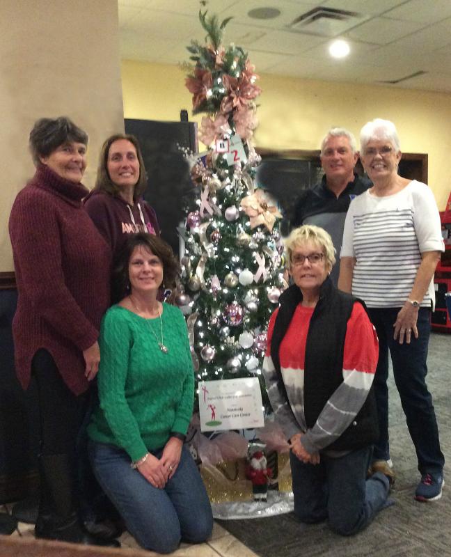 Members and friends of the Seaford 9 Hole Ladies Golf Association stand next to the Pretty in Pink Tree they proudly decorated to support the Allen Cancer Center at Nanticoke Memorial Hospital. Pictured are (l-r standing) Debi Thomas, Tina Hurley, Brian Short, and Cathie Jo Jones (l-r kneeling) Trisha Newcomer and Arsie Burton.
